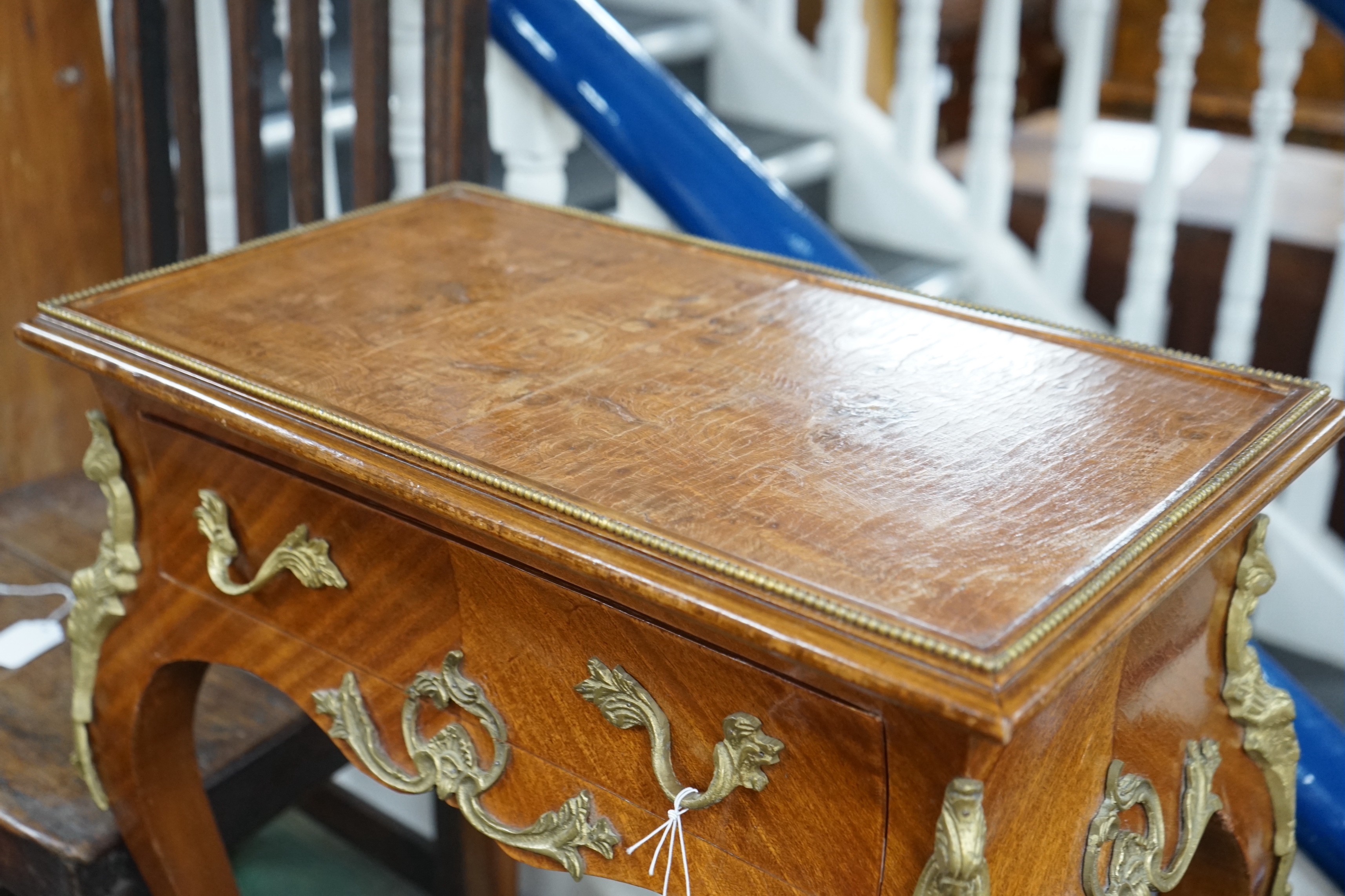 A Louis XVI style gilt metal mounted side table, width 56cm, depth 33cm, height 76cm